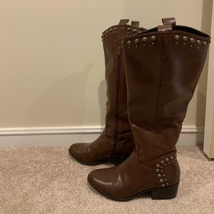 Brown riding boots with copper embellishments